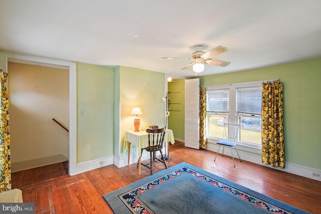 living area featuring hardwood / wood-style flooring and ceiling fan