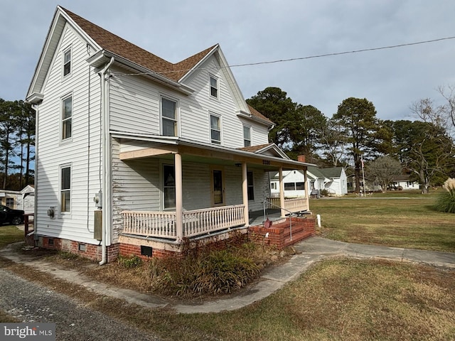 farmhouse with a porch and a front lawn