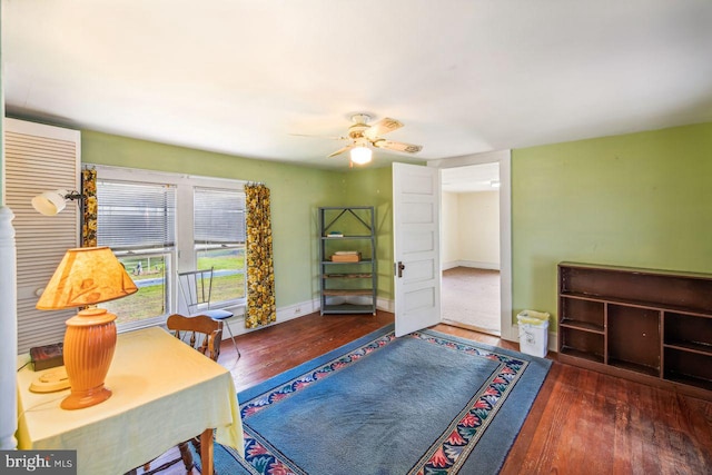 interior space with ceiling fan and dark hardwood / wood-style floors