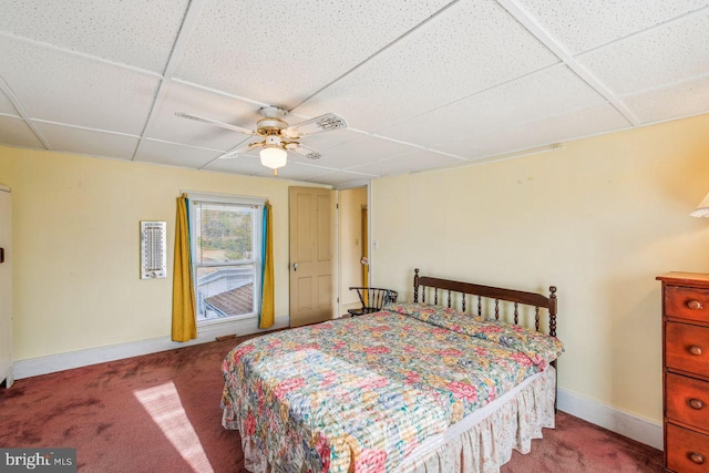 bedroom featuring a paneled ceiling, carpet floors, and ceiling fan