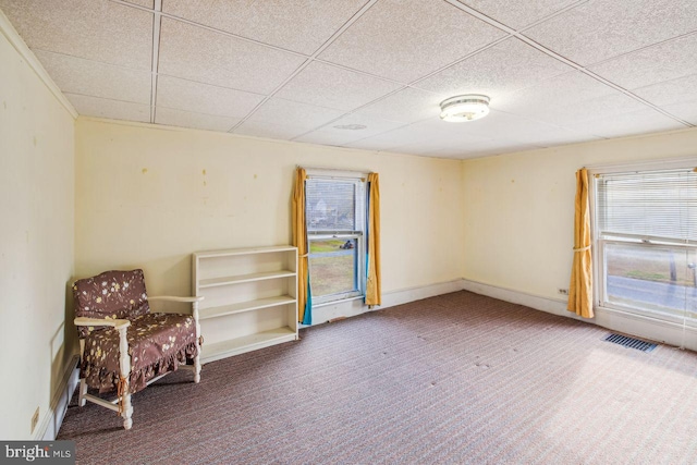 unfurnished room featuring a paneled ceiling and carpet floors