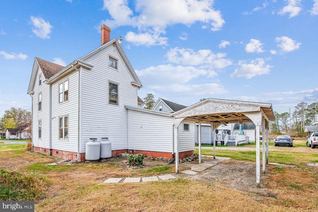 rear view of property with a lawn