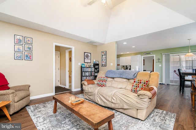 living room featuring ceiling fan, high vaulted ceiling, and dark wood-type flooring