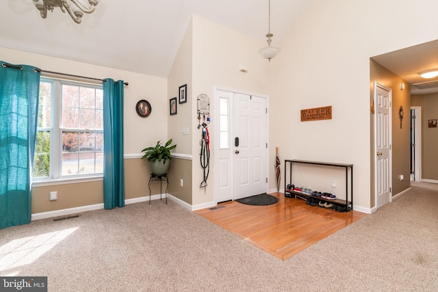 entrance foyer featuring hardwood / wood-style flooring and vaulted ceiling