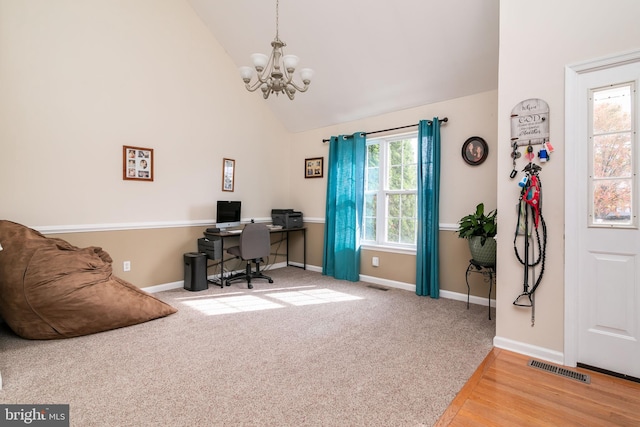 office space with wood-type flooring, an inviting chandelier, high vaulted ceiling, and plenty of natural light