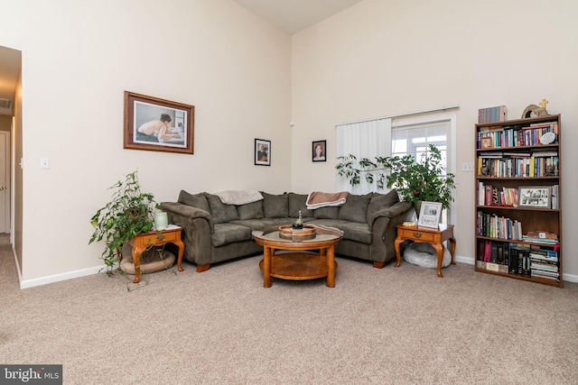 living room with carpet and a towering ceiling