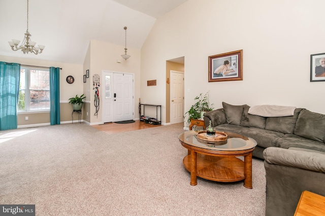 living room with a notable chandelier, light colored carpet, and high vaulted ceiling