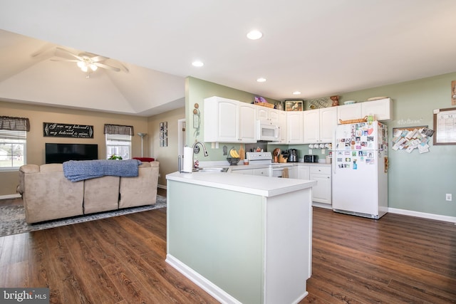 kitchen with kitchen peninsula, white appliances, dark wood-type flooring, sink, and white cabinets