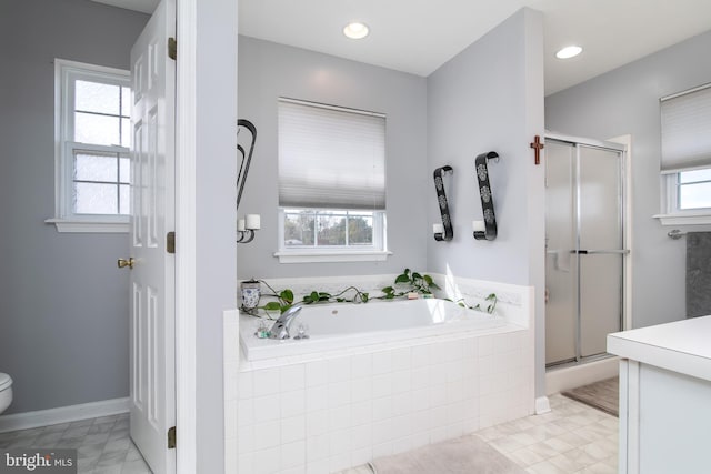 bathroom featuring tile patterned flooring, shower with separate bathtub, and a wealth of natural light