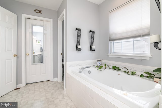 bathroom with tiled bath