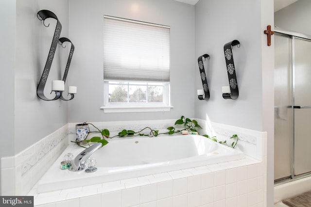 bathroom featuring shower with separate bathtub