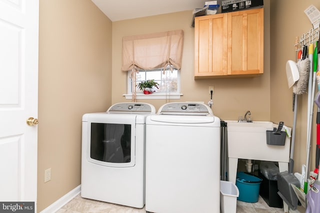 laundry room with cabinets, independent washer and dryer, and light tile patterned flooring