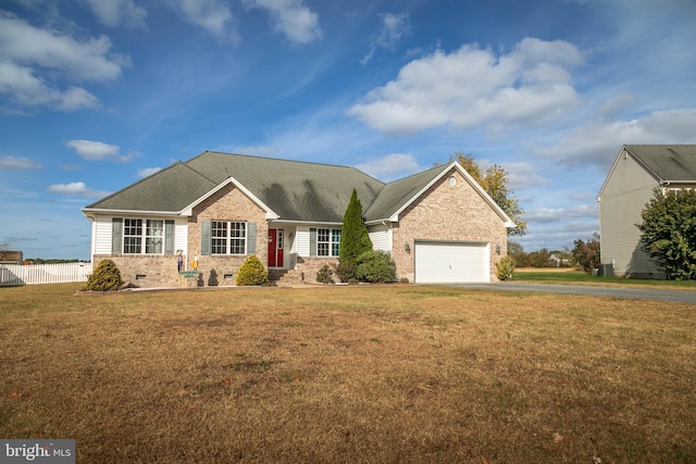 view of front of property featuring a front yard and a garage