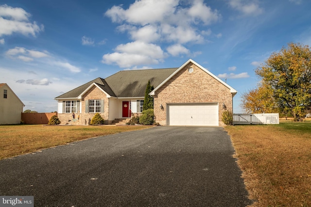 ranch-style house with a garage and a front lawn