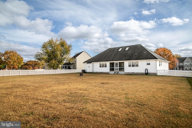 rear view of property with a yard