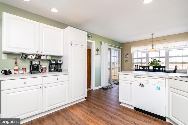 kitchen with hanging light fixtures, dishwasher, white cabinets, and dark wood-type flooring