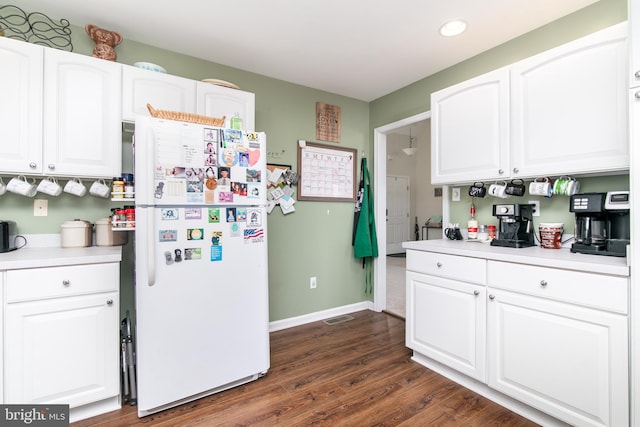 kitchen featuring white refrigerator, dark hardwood / wood-style floors, and white cabinetry