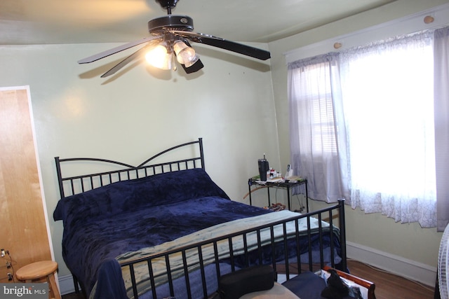 bedroom featuring ceiling fan, vaulted ceiling, and hardwood / wood-style flooring