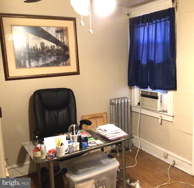 office area with radiator and dark hardwood / wood-style floors