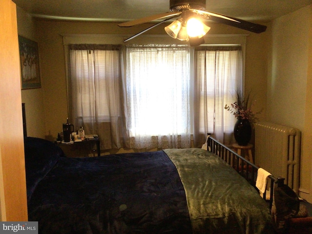 bedroom with radiator and ceiling fan