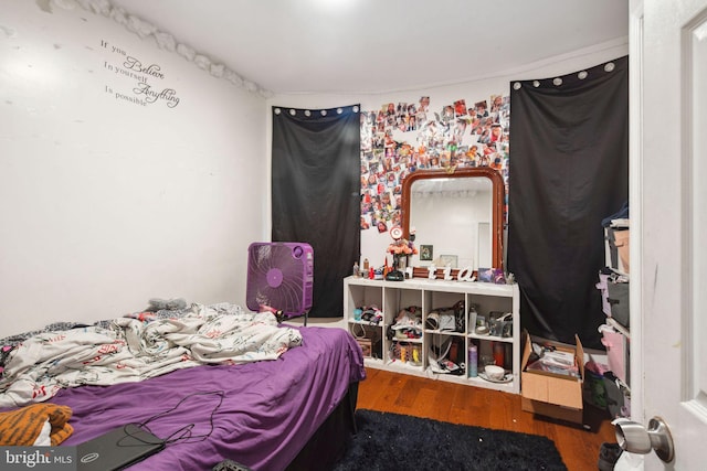 bedroom with hardwood / wood-style floors