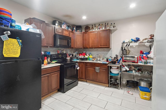 kitchen with backsplash, sink, and black appliances