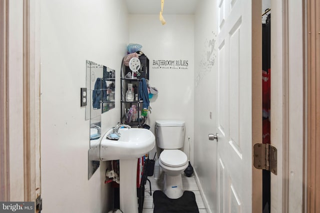 bathroom with tile patterned flooring and toilet