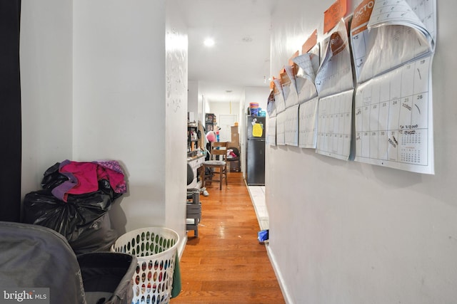 hallway with hardwood / wood-style floors