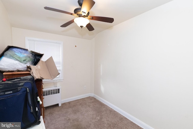 interior space with light carpet, radiator, and ceiling fan