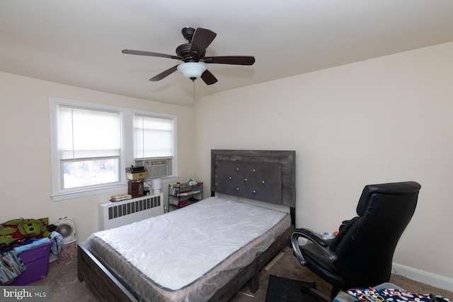 carpeted bedroom with ceiling fan, cooling unit, and radiator