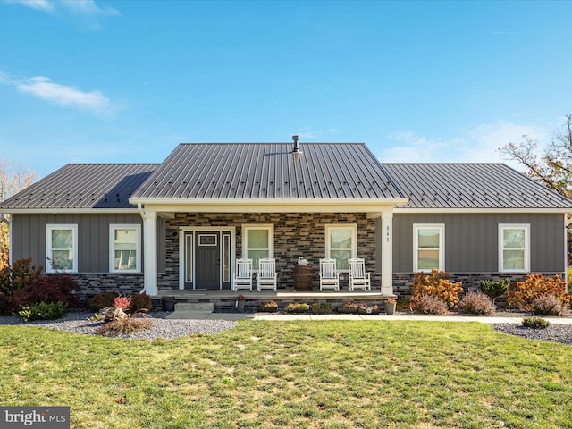 view of front of home with a porch and a front yard