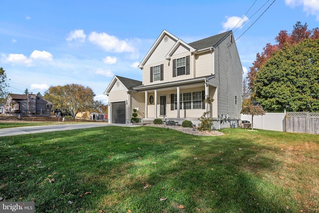 view of front of home featuring a front lawn, covered porch, and a garage