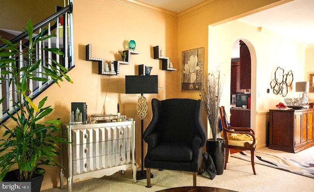 sitting room featuring light colored carpet and crown molding