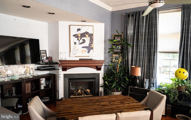 living area featuring ornamental molding, hardwood / wood-style floors, and ceiling fan