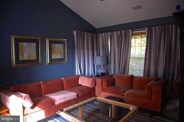 living room featuring lofted ceiling