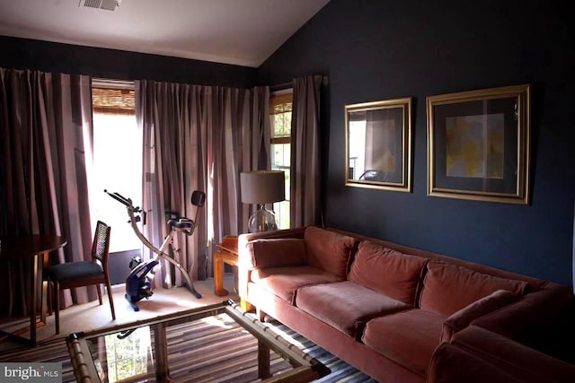 living room featuring vaulted ceiling and carpet flooring