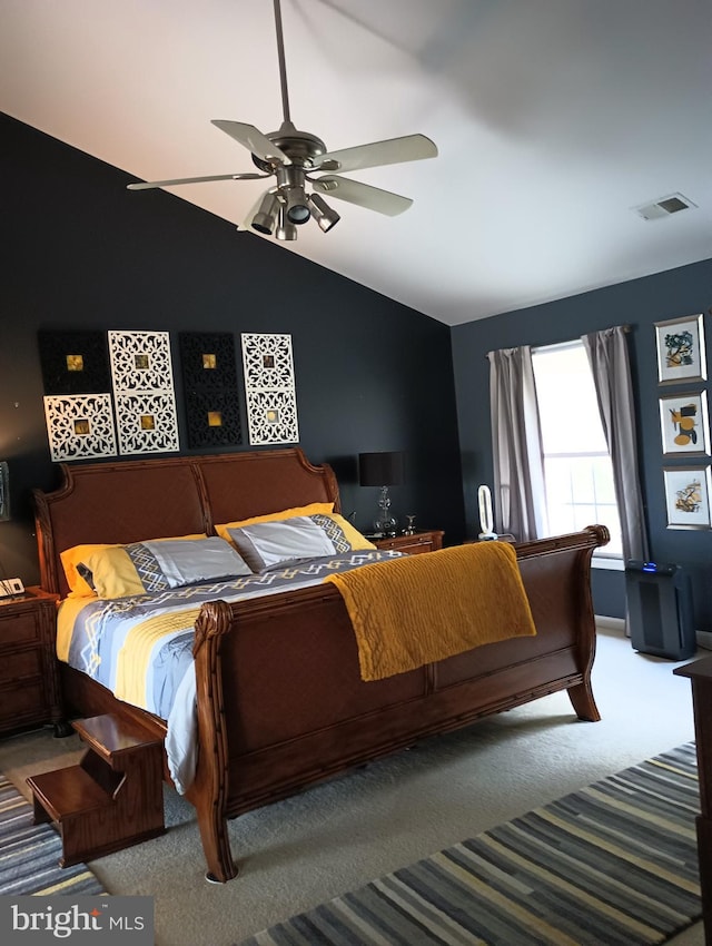 bedroom featuring carpet floors, lofted ceiling, and ceiling fan