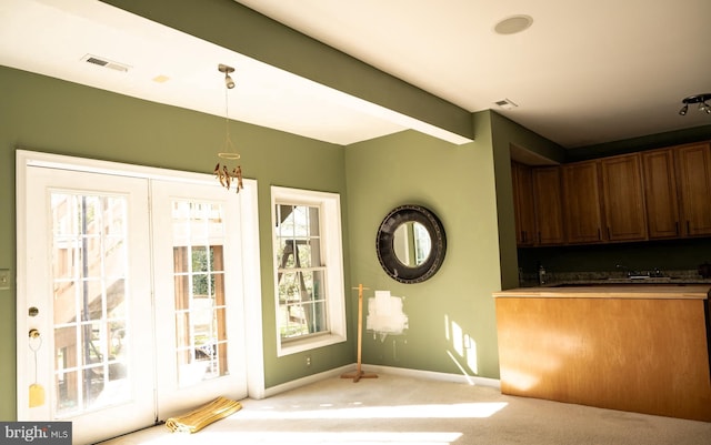 entryway featuring light carpet