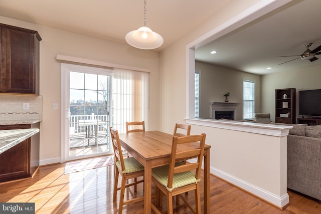 dining room featuring ceiling fan and light wood-type flooring