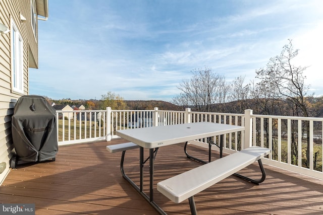 wooden terrace featuring grilling area