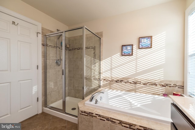 bathroom featuring shower with separate bathtub, vanity, and tile patterned floors