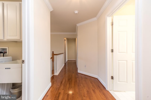 hall with hardwood / wood-style floors and crown molding