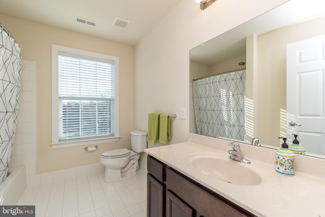 full bathroom featuring tile patterned flooring, vanity, shower / bath combo with shower curtain, and toilet