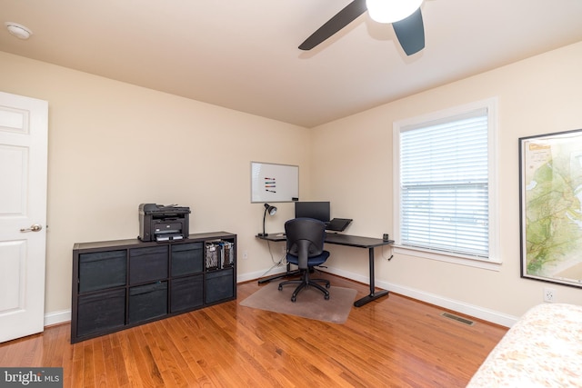 office area with light wood-type flooring and ceiling fan