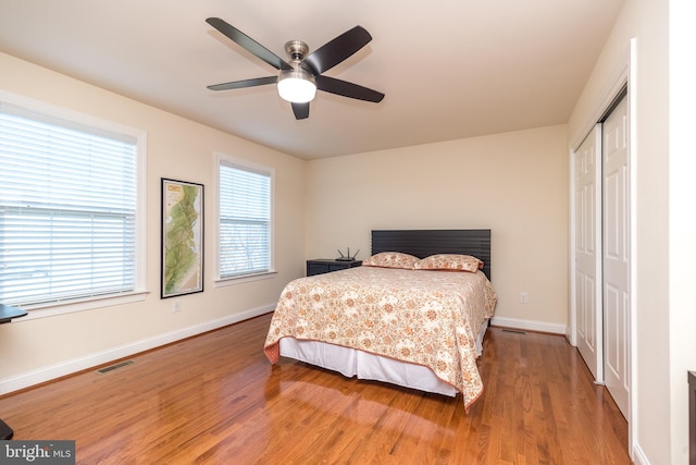 bedroom featuring a closet, hardwood / wood-style flooring, and ceiling fan