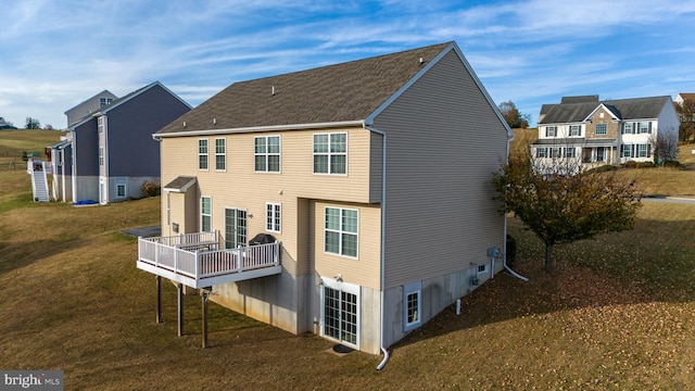 rear view of house featuring a yard