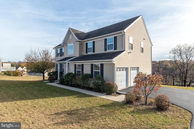 view of front of property with a garage and a front lawn