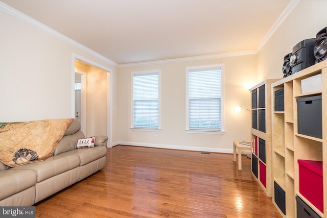 living room featuring wood-type flooring and ornamental molding