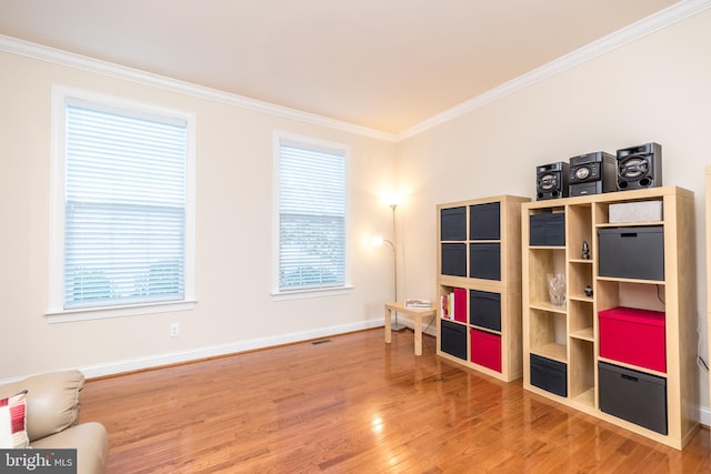 misc room featuring hardwood / wood-style floors and crown molding