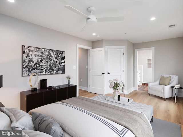 bedroom with ceiling fan and light hardwood / wood-style floors